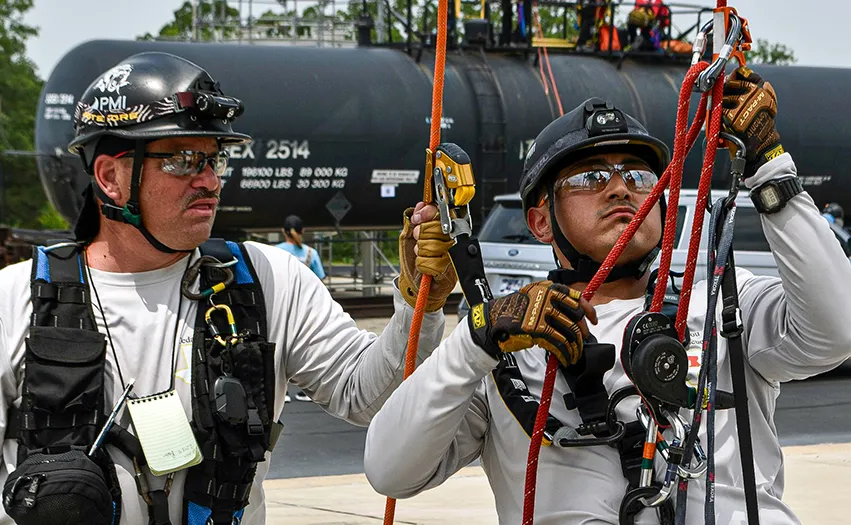 Two people wearing climbing gear (Photo)