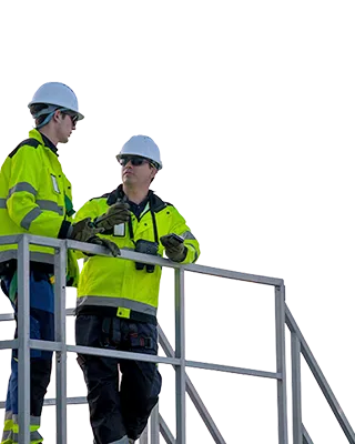 Two workers with safety jackets and hemets discussing (photo)