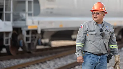 A worker on a rail yard looking into the distance (Photo)